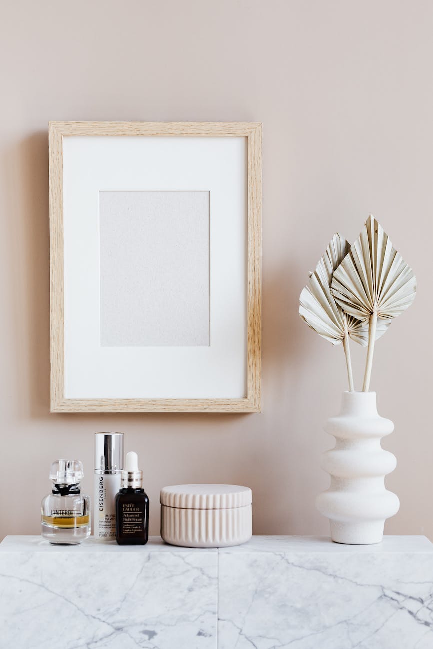 stylish minimalistic composition of cosmetics vase and wall frame