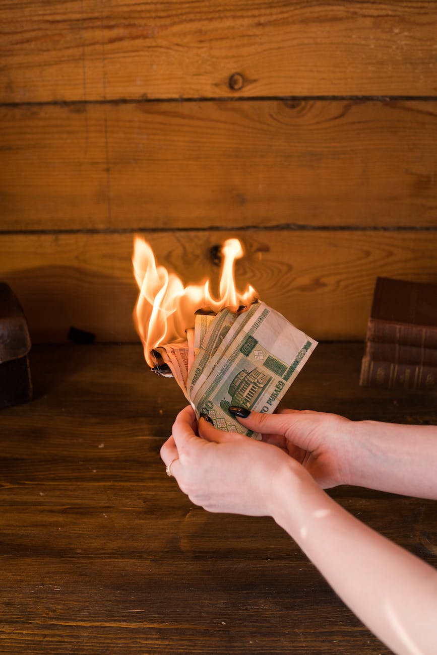 woman holding burning banknotes